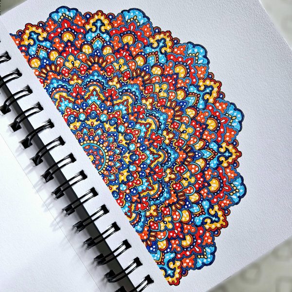 Red, blue and orange mandala art created by Noor Khan with gel pens on mixed media paper